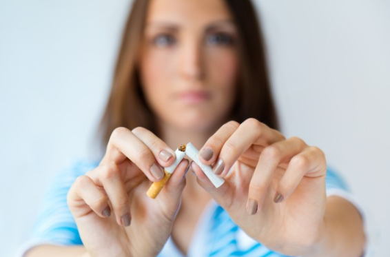 Woman breaking cigarette